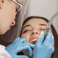 dentist-doing-a-dental-treatment-on-a-female-patie-2022-05-26-21-49-28-utc