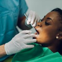 dentist-providing-dental-care-treatment-to-a-afric-2022-05-24-00-00-31-utc (1)