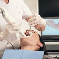 female-dentist-scanning-teeth-of-woman-2022-03-04-05-56-00-utc (2) (1)