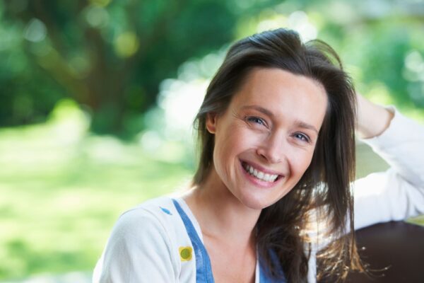 smiling-woman-sitting-outdoors-2022-03-04-01-52-53-utc (2) (1)