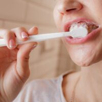 woman-brushing-teeth-2022-11-16-21-46-57-utc (2) (1)